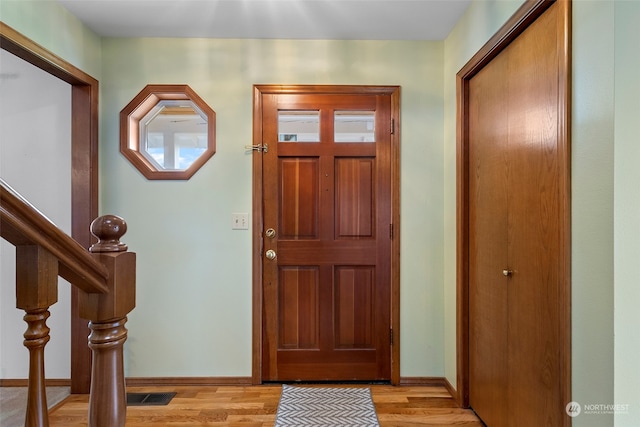 foyer entrance with light hardwood / wood-style flooring