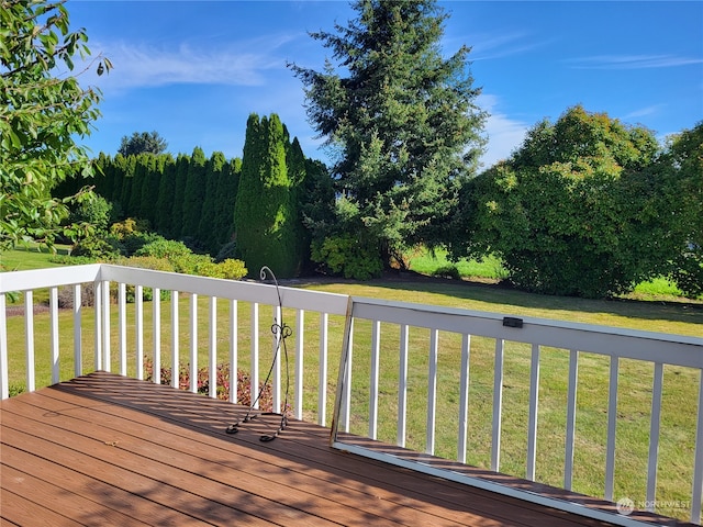 wooden deck featuring a yard