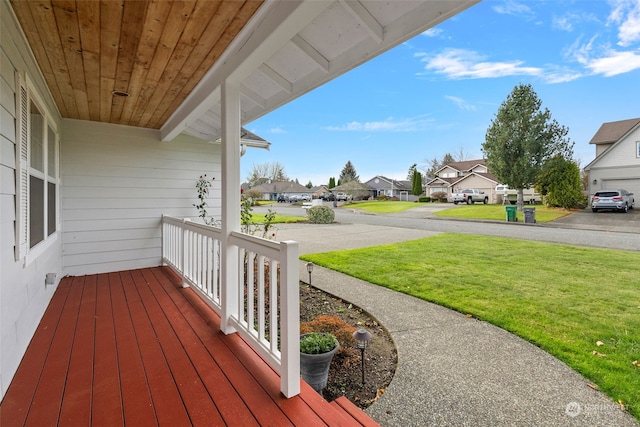 deck with a lawn and a porch