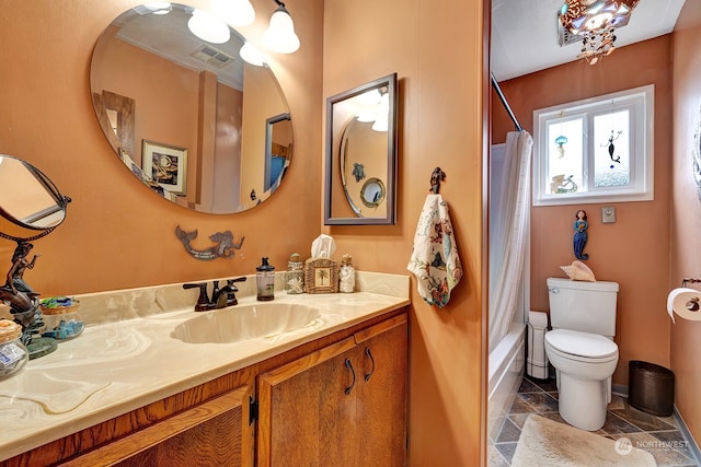 full bathroom with vanity, toilet, and shower / bath combo with shower curtain