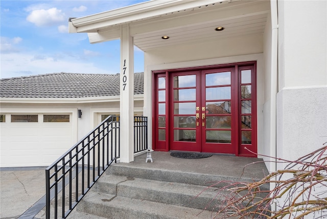 property entrance featuring french doors and a garage