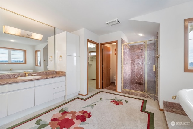 bathroom with vanity, a shower with shower door, and toilet