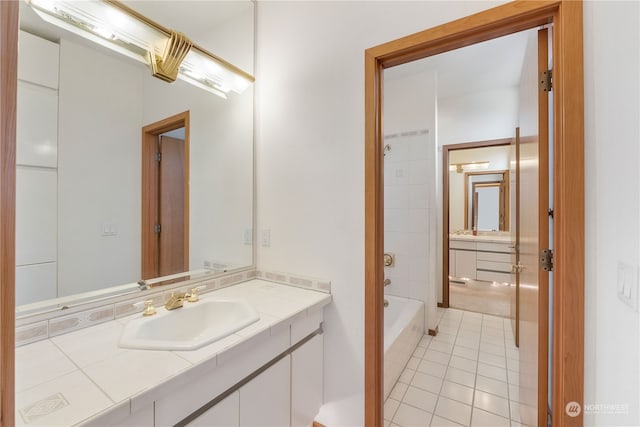 bathroom with tile patterned flooring, vanity, and tiled shower / bath combo