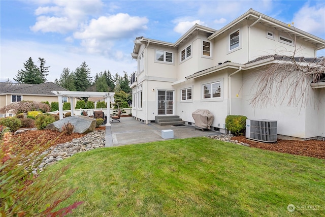 back of house featuring a pergola, a patio, cooling unit, and a lawn