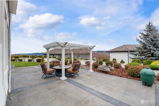 view of patio / terrace featuring a pergola and a mountain view