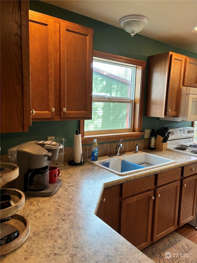 kitchen with white appliances and sink