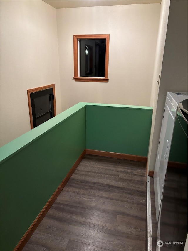 interior space with dark hardwood / wood-style floors and washing machine and clothes dryer