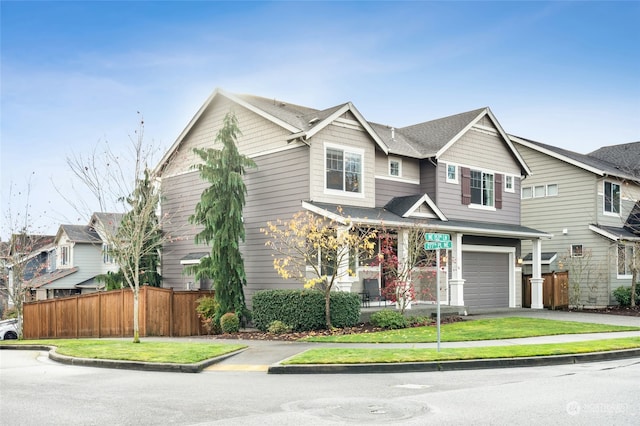 view of front of property featuring a front yard and a garage