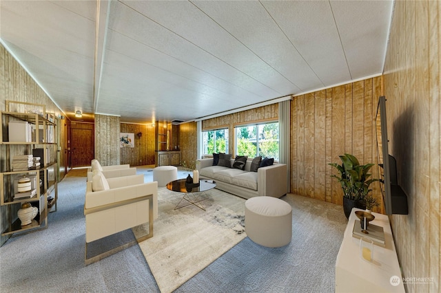 living room with wooden walls and carpet flooring