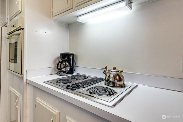 kitchen featuring cooktop and white oven