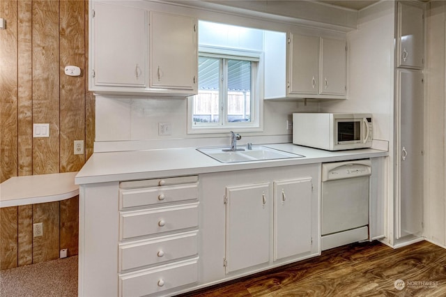 kitchen featuring white cabinetry, white appliances, sink, and wood walls