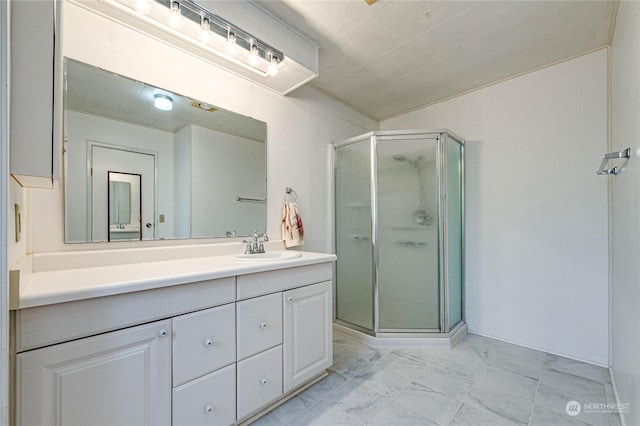 bathroom featuring vanity and a shower with shower door