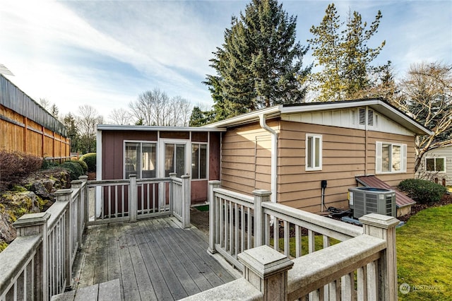 wooden terrace featuring a sunroom and central air condition unit