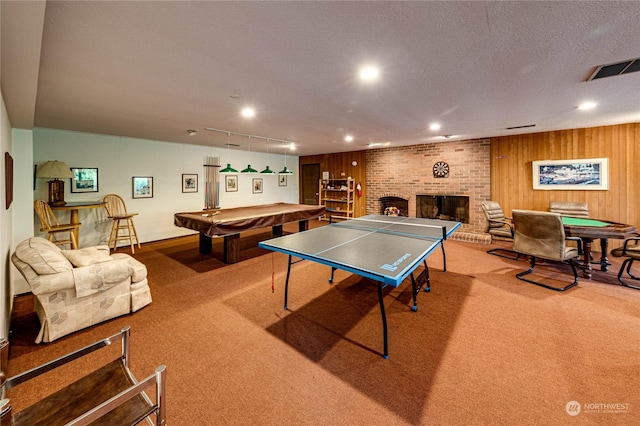 game room featuring billiards, carpet flooring, a brick fireplace, track lighting, and a textured ceiling