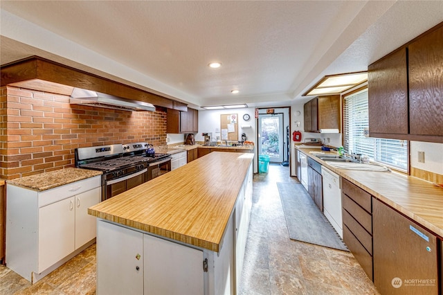 kitchen featuring white cabinetry, dishwasher, gas range, wall chimney range hood, and electric stove