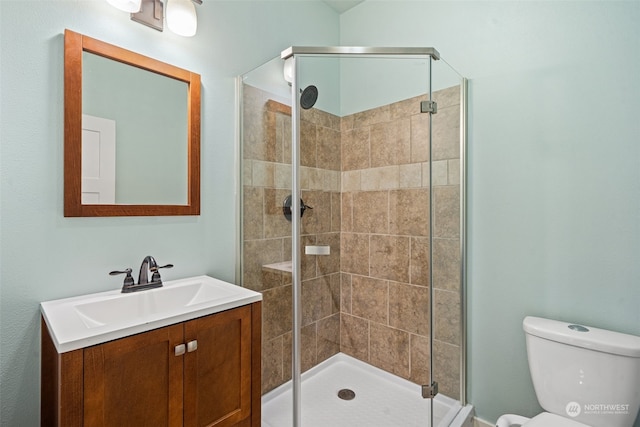 bathroom with vanity, toilet, and walk in shower