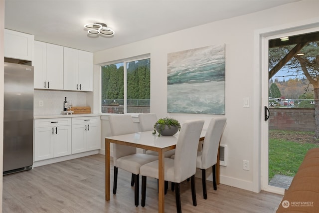 dining area featuring a healthy amount of sunlight and light hardwood / wood-style flooring