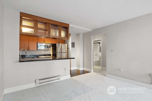 kitchen featuring appliances with stainless steel finishes and a baseboard heating unit