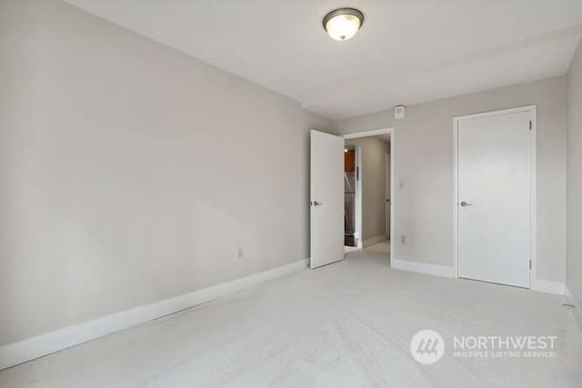 unfurnished bedroom with light colored carpet