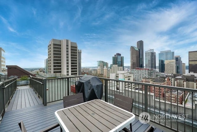 1105 Spring St Unit 701, Seattle, WA 98104 - wooden terrace with a view of skyline and area for grilling