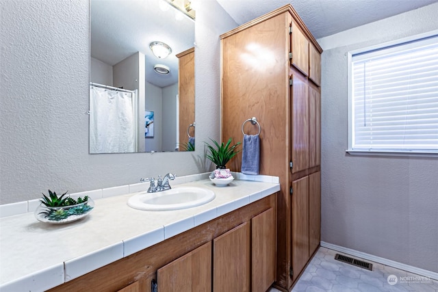 bathroom featuring tile patterned flooring and vanity