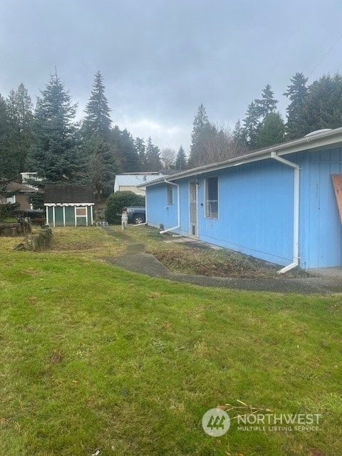 rear view of property featuring a yard