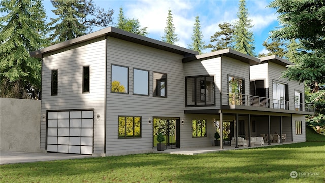 rear view of property featuring a lawn, a garage, a balcony, and a patio area