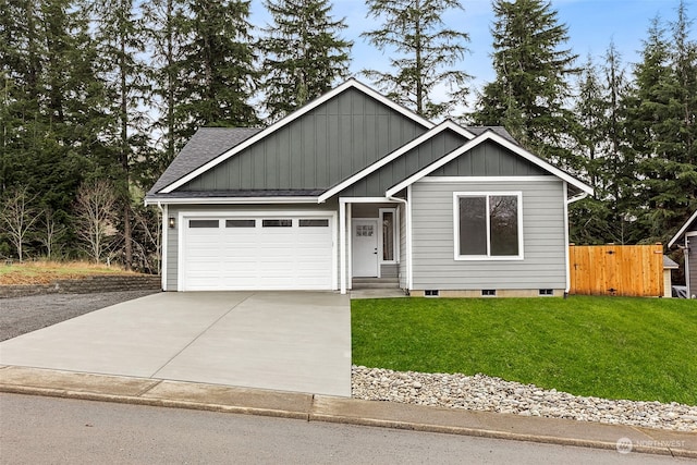 view of front of home with a garage and a front lawn