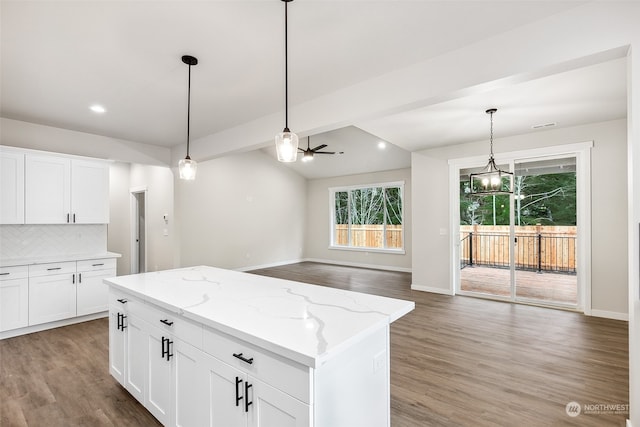 kitchen featuring light stone countertops, hardwood / wood-style floors, white cabinetry, and ceiling fan