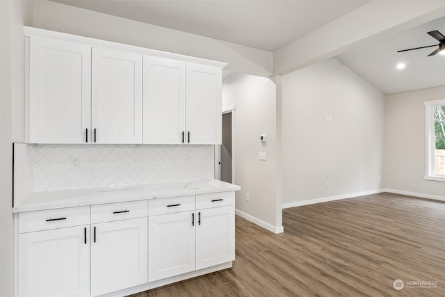 kitchen with decorative backsplash, ceiling fan, white cabinetry, and dark wood-type flooring