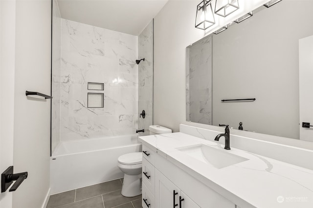 full bathroom with tile patterned floors, vanity, tiled shower / bath combo, and toilet