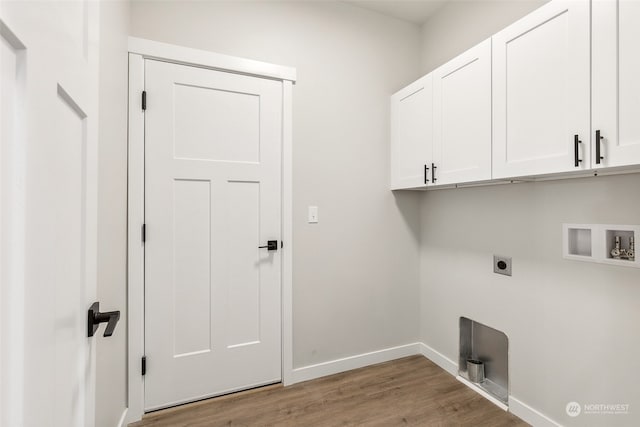 laundry area featuring cabinets, hookup for a washing machine, light hardwood / wood-style floors, and hookup for an electric dryer