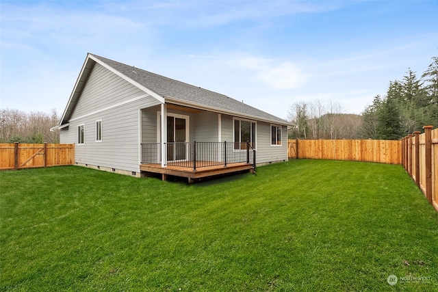 rear view of property with a wooden deck and a yard