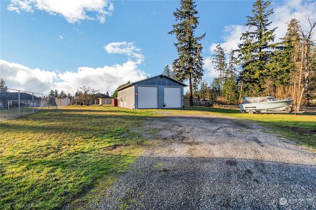 view of yard featuring an outbuilding and a garage