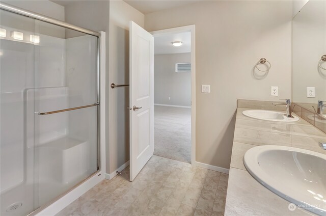 bathroom featuring vanity and a shower with door