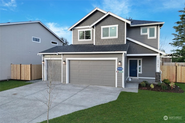 craftsman-style house featuring a garage and a front yard