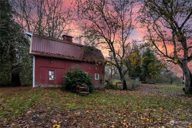 516 SW Riverside Dr, Chehalis, WA 98532 - property exterior at dusk featuring a metal roof and a chimney