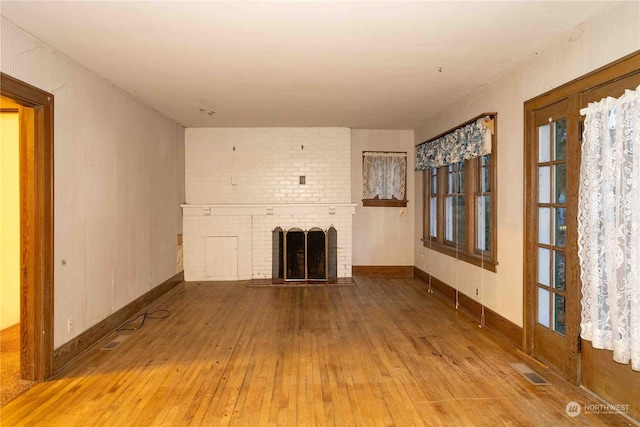 516 SW Riverside Dr, Chehalis, WA 98532 - unfurnished living room featuring hardwood / wood-style floors and a brick fireplace