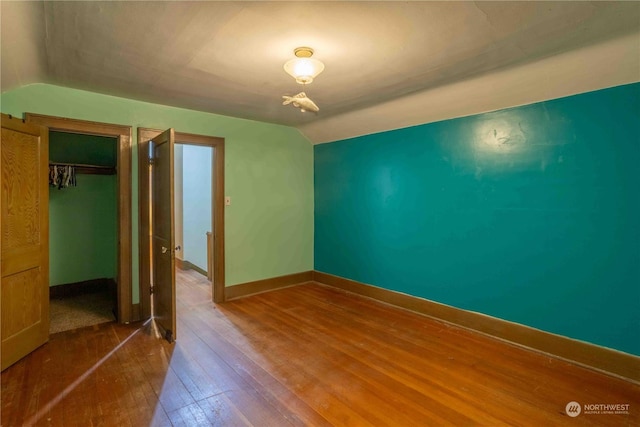 516 SW Riverside Dr, Chehalis, WA 98532 - unfurnished bedroom with vaulted ceiling, hardwood / wood-style flooring, and a closet