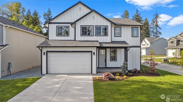 view of front of home featuring a garage and a front yard