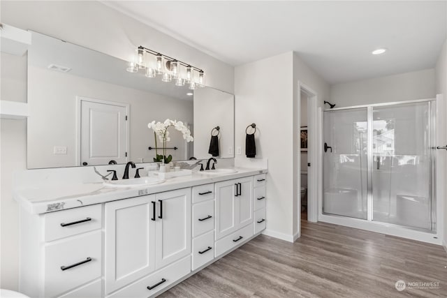bathroom featuring hardwood / wood-style flooring, vanity, toilet, and walk in shower