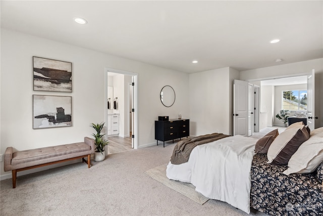 carpeted bedroom featuring ensuite bath