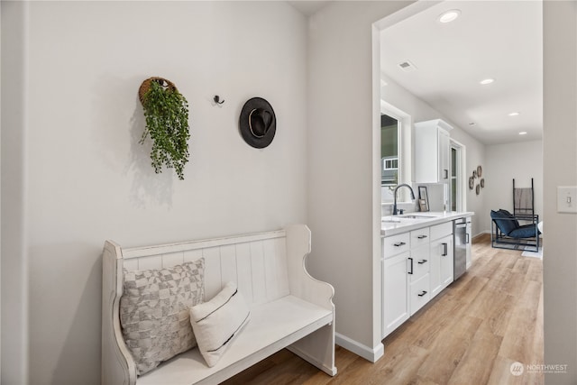 interior space featuring sink and light hardwood / wood-style flooring