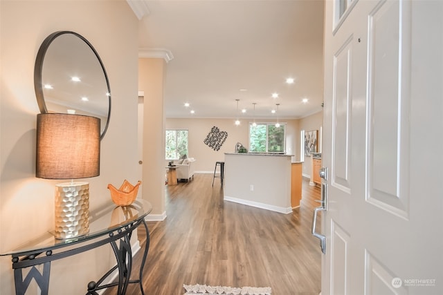 corridor with crown molding and light hardwood / wood-style flooring