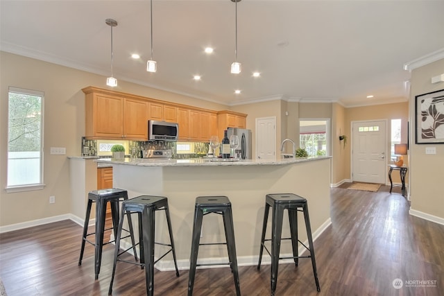 kitchen featuring dark wood-type flooring, stainless steel appliances, light stone counters, crown molding, and pendant lighting