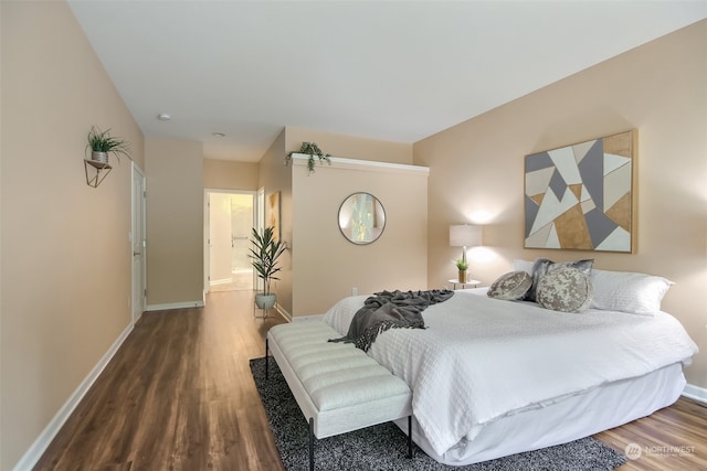 bedroom featuring hardwood / wood-style flooring and ensuite bath