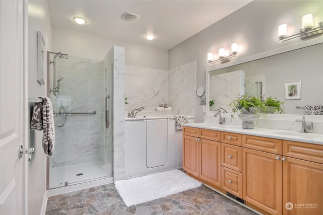 bathroom with vanity and a shower with shower door