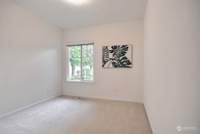 empty room featuring light colored carpet