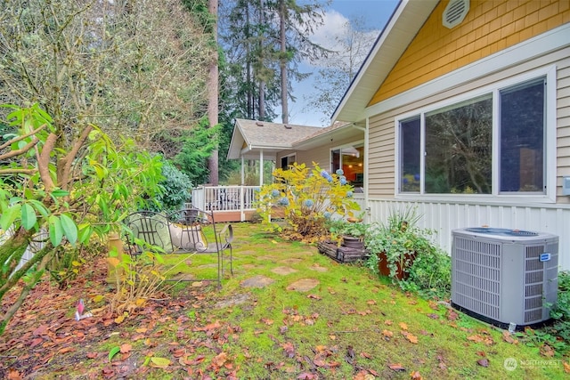 view of yard with a deck and central AC unit