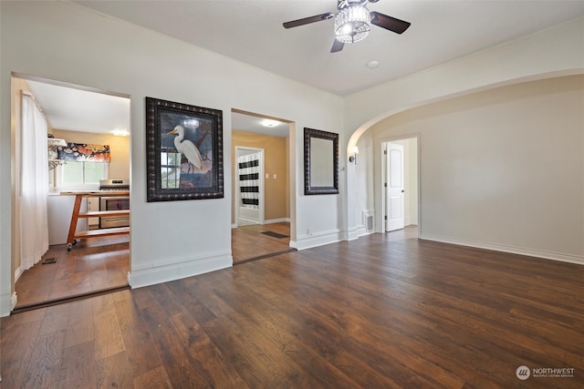 spare room featuring ceiling fan and dark hardwood / wood-style flooring